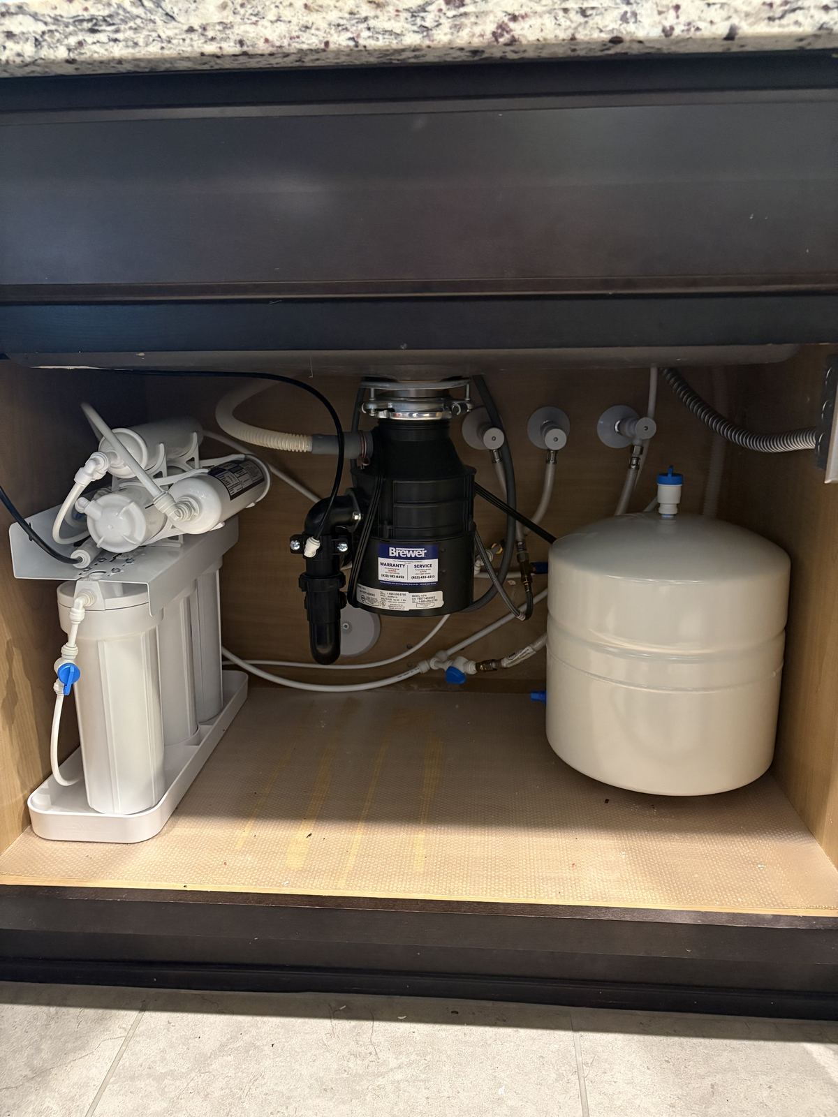 Reverse osmosis drinking water system installed under kitchen sink