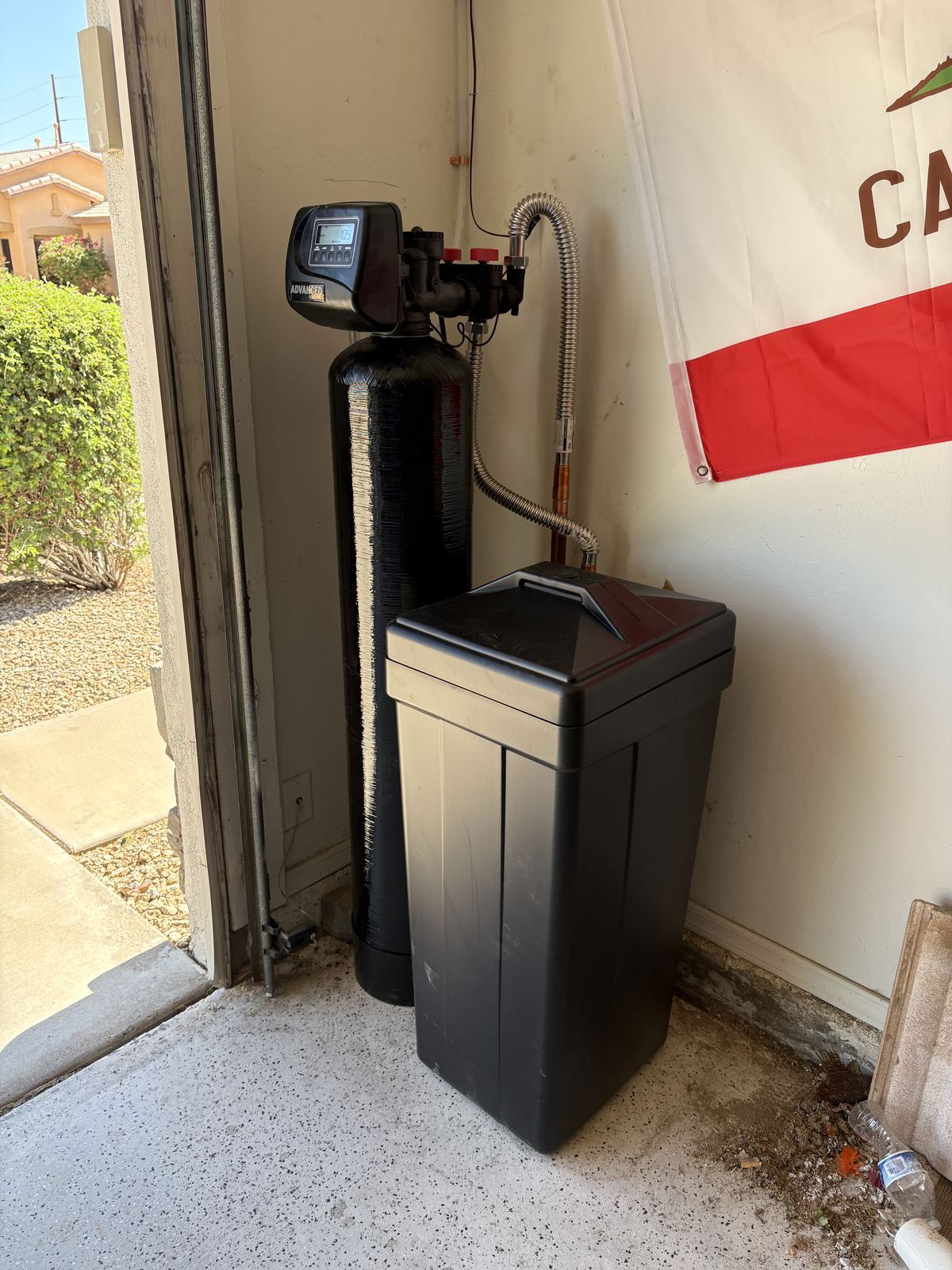 Water softener system installed at a home entryway